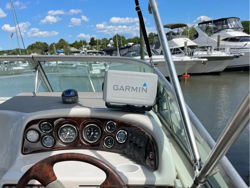 Slide: The Image of Crownline 242 CR 2002 boat dashboard with Garmin GPS at marina. - 1