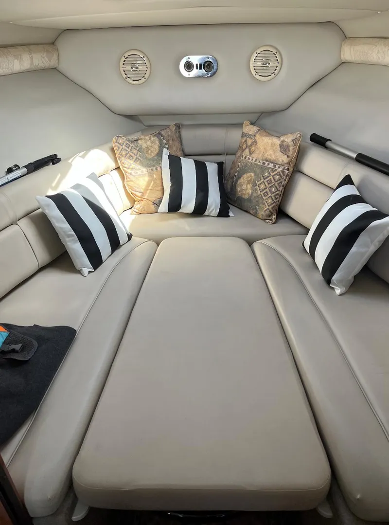 Slide: The Image of Interior cabin of a 2002 Crownline 242 CR boat with cushions and pillows. - 6
