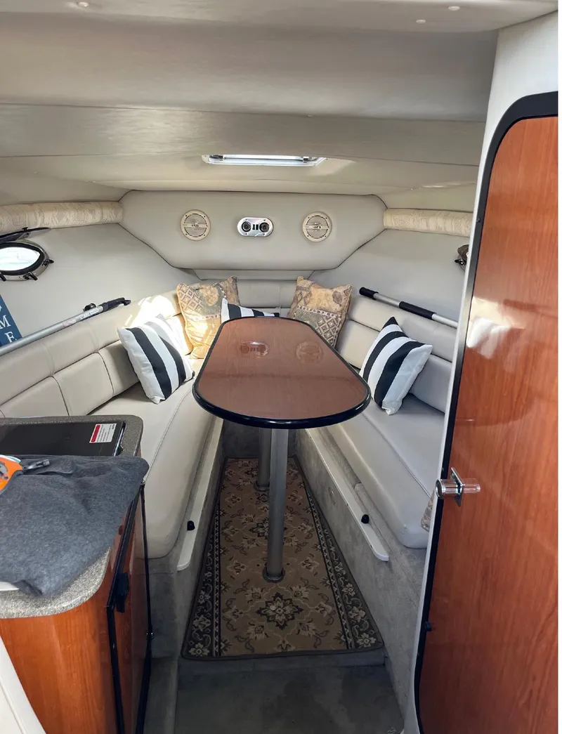 Slide: The Image of Interior cabin of a 2002 Crownline 242 CR boat with seating and table. - 8
