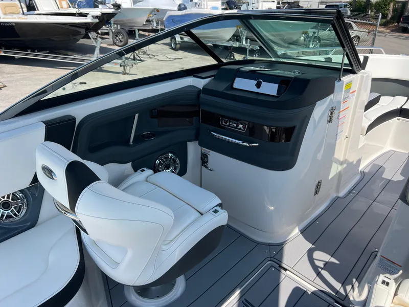Slide: The Image of 2024 Chaparral 270 OSX boat interior with helm and seating. - 10