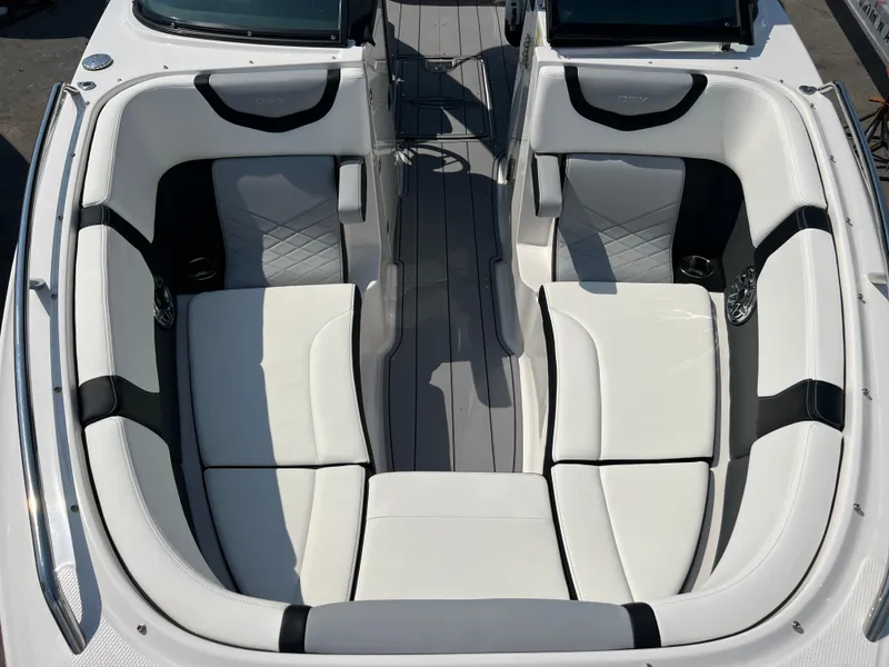 Slide: The Image of 2024 Chaparral 270 OSX boat interior with white and black seating. - 12