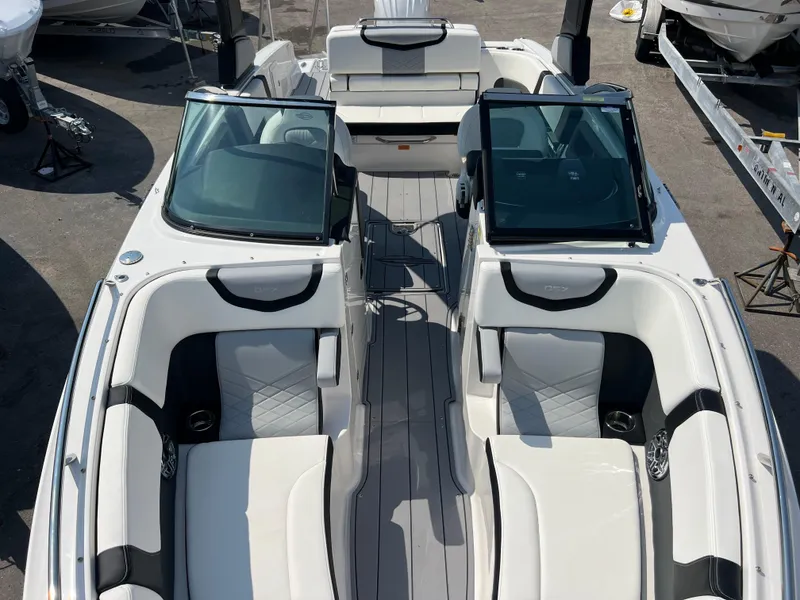 Slide: The Image of 2024 Chaparral 270 OSX boat interior with dual consoles and luxurious seating. - 13