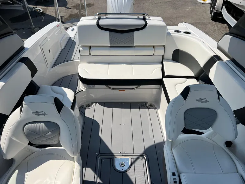 Slide: The Image of 2024 Chaparral 270 OSX boat interior with white leather seating and modern design. - 16