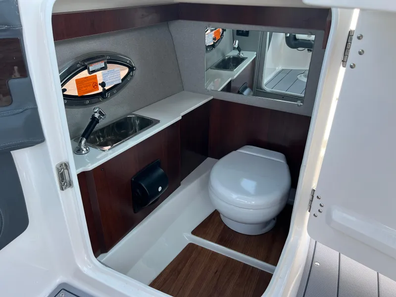 Slide: The Image of 2024 Chaparral 270 OSX boat interior bathroom with sink and toilet. - 17