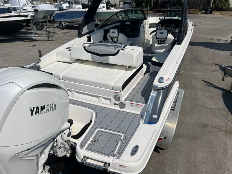 Slide: The Image of 2024 Chaparral 270 OSX boat with Yamaha engine, rear seating, and modern interior. - 4