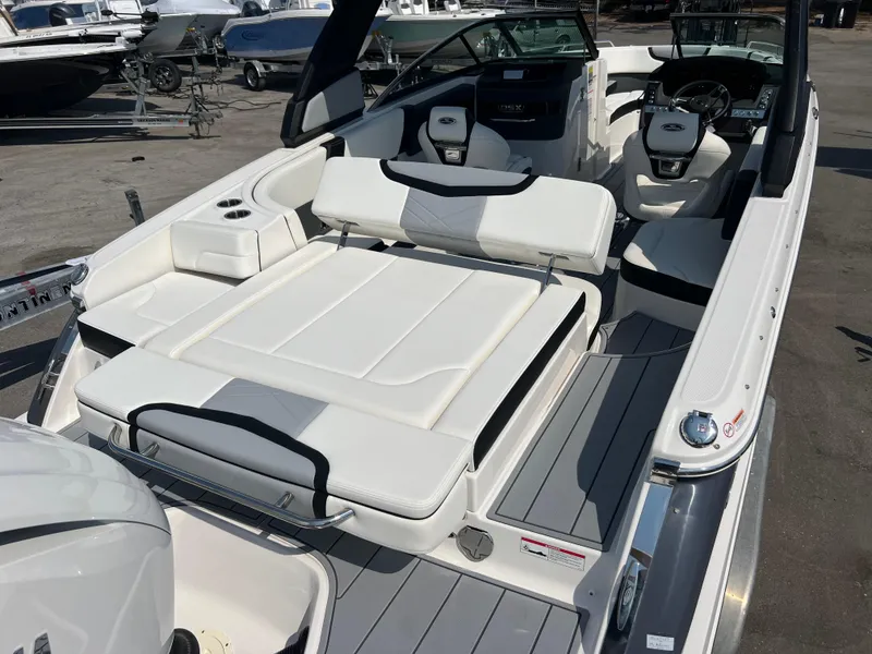 Slide: The Image of 2024 Chaparral 270 OSX boat interior with white seating and modern dashboard. - 5