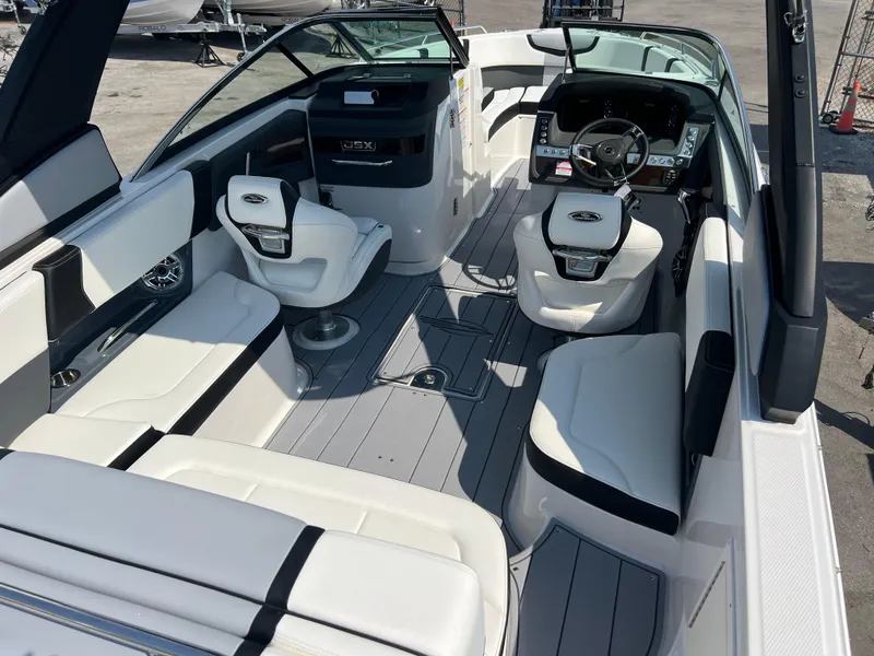 Slide: The Image of 2024 Chaparral 270 OSX boat interior with white seating and modern dashboard. - 6