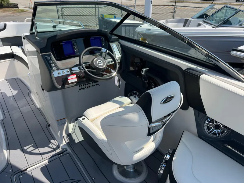 Slide: The Image of 2024 Chaparral 270 OSX boat cockpit with modern steering and control panel. - 8