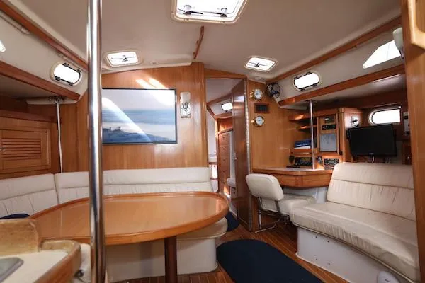 Slide: The Image of Interior of 2002 Catalina 42 MK 2 sailboat with wood finish and seating area. - 10