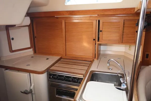 Slide: The Image of 2002 Catalina 42 MK 2 yacht kitchen with wooden cabinets and stainless steel sink. - 12