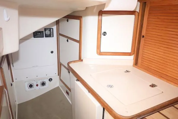 Slide: The Image of Interior of 2002 Catalina 42 MK 2 sailboat, featuring compact kitchen area. - 15
