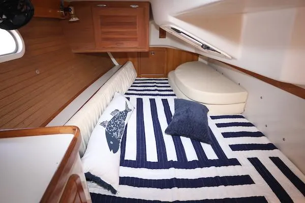 Slide: The Image of Cozy cabin interior of 2002 Catalina 42 MK 2 sailboat with striped bedding. - 17