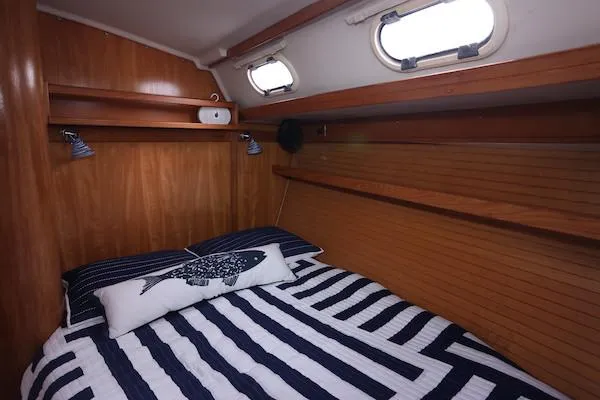 Slide: The Image of Cozy cabin interior of 2002 Catalina 42 MK 2 sailboat with striped bedding. - 20