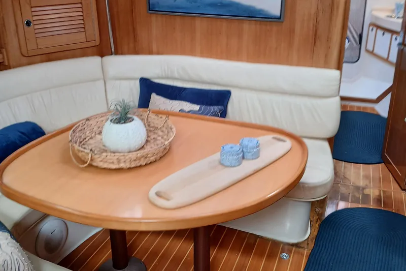 Slide: The Image of Interior of 2002 Catalina 42 MK 2 sailboat with dining table and cushioned seating. - 31