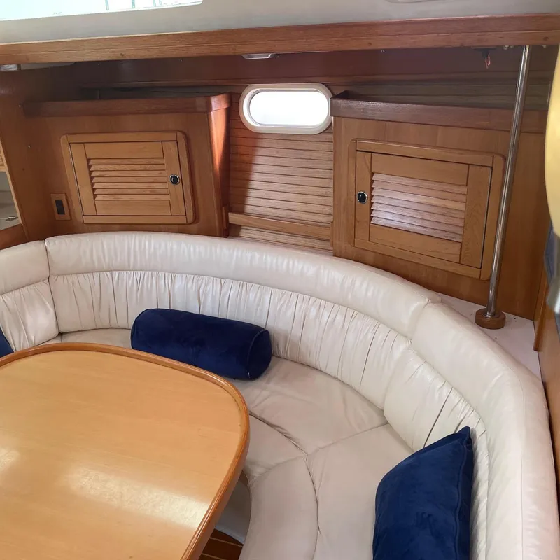 Slide: The Image of 2002 Catalina 42 MK 2 yacht interior with curved seating and wooden cabinetry. - 34
