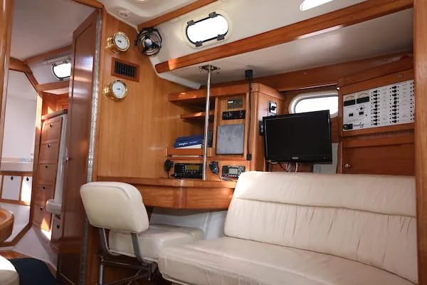 Slide: The Image of Interior of 2002 Catalina 42 MK 2 yacht with wood paneling and navigation equipment. - 42