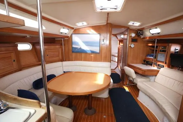 Slide: The Image of Interior of 2002 Catalina 42 MK 2 sailboat with wood finish and cozy seating area. - 6