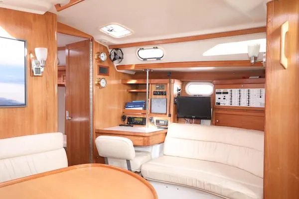 Slide: The Image of Interior of 2002 Catalina 42 MK 2 sailboat with wood finish and navigation equipment. - 7