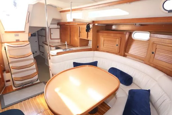 Slide: The Image of Interior of 2002 Catalina 42 MK 2 sailboat with cozy seating and wooden cabinetry. - 8