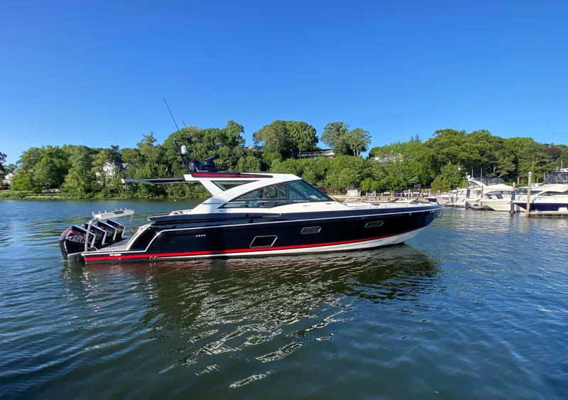 Slide: The Image of 2021 Formula 430 Super Sport Crossover boat on a sunny day in a marina. - 0
