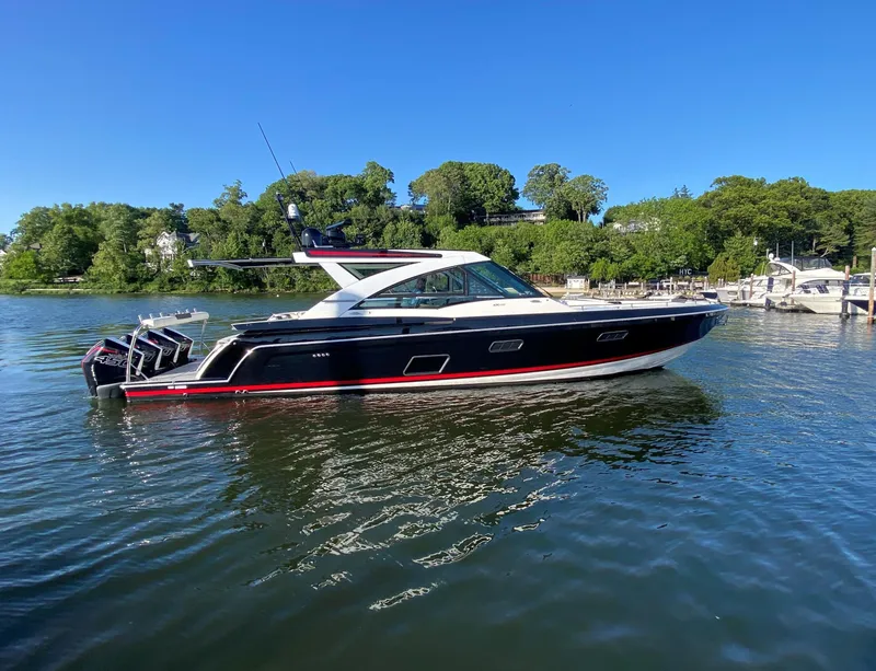 Slide: The Image of 2021 Formula 430 Super Sport Crossover boat on a serene lake. - 2