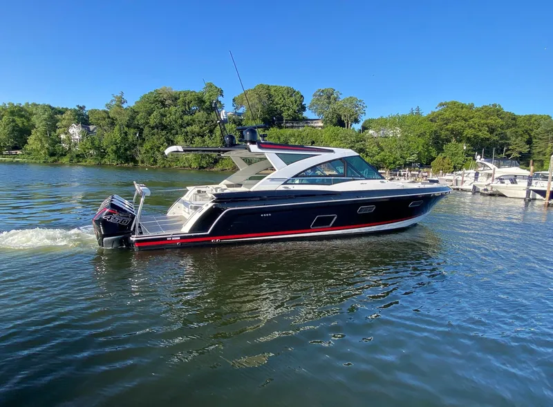 Slide: The Image of 2021 Formula 430 Super Sport Crossover cruising on a scenic lake. - 3
