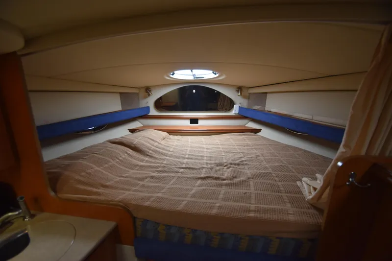 Slide: The Image of 2004 Cruisers Yachts 320 Express cabin interior with bed. - 10