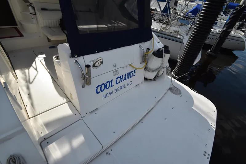 Slide: The Image of 2004 Cruisers Yachts 320 Express boat docked, named 'Cool Change'. - 12