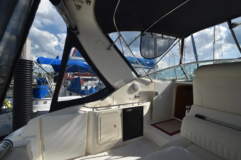 Slide: The Image of Interior of a 2004 Cruisers Yachts 320 Express with marina view. - 16