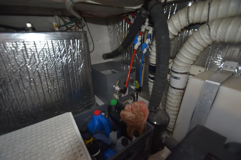 Slide: The Image of Engine room of 2004 Cruisers Yachts 320 Express with hoses and equipment. - 18