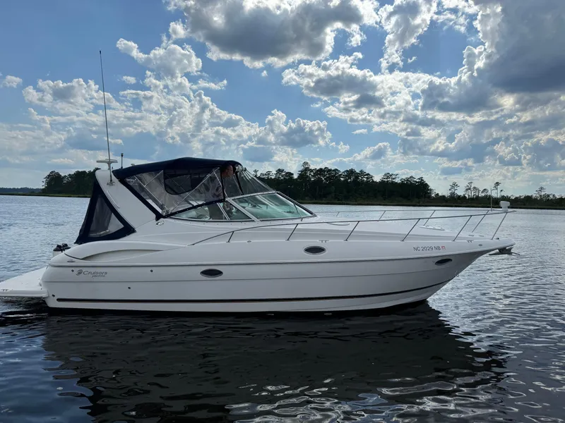 Slide: The Image of 2004 Cruisers Yachts 320 Express on calm water under cloudy sky. - 20