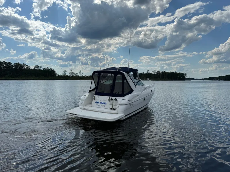 Slide: The Image of 2004 Cruisers Yachts 320 Express on calm water under cloudy sky. - 21