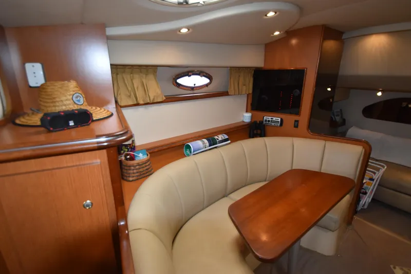 Slide: The Image of Interior of 2004 Cruisers Yachts 320 Express with seating area and table. - 4