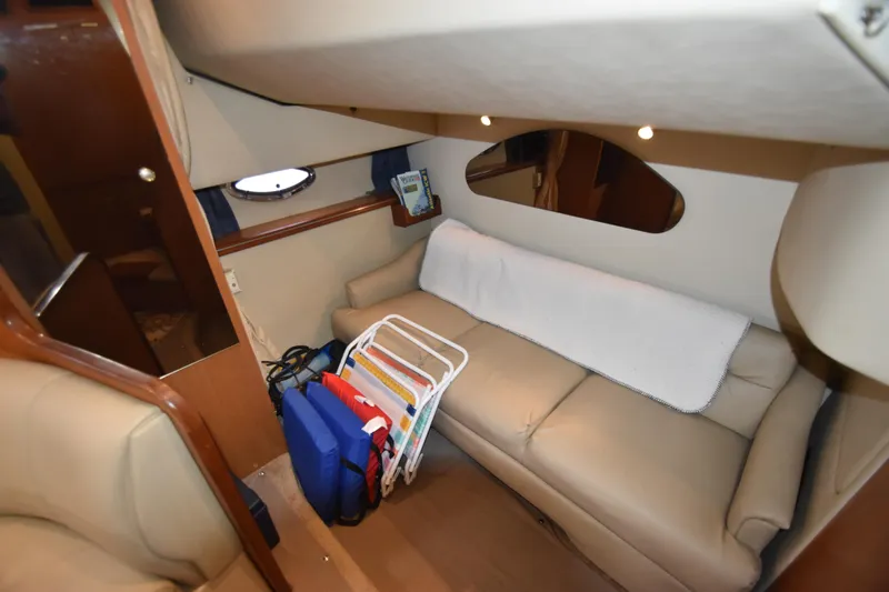 Slide: The Image of Interior of 2004 Cruisers Yachts 320 Express with sofa and window. - 6