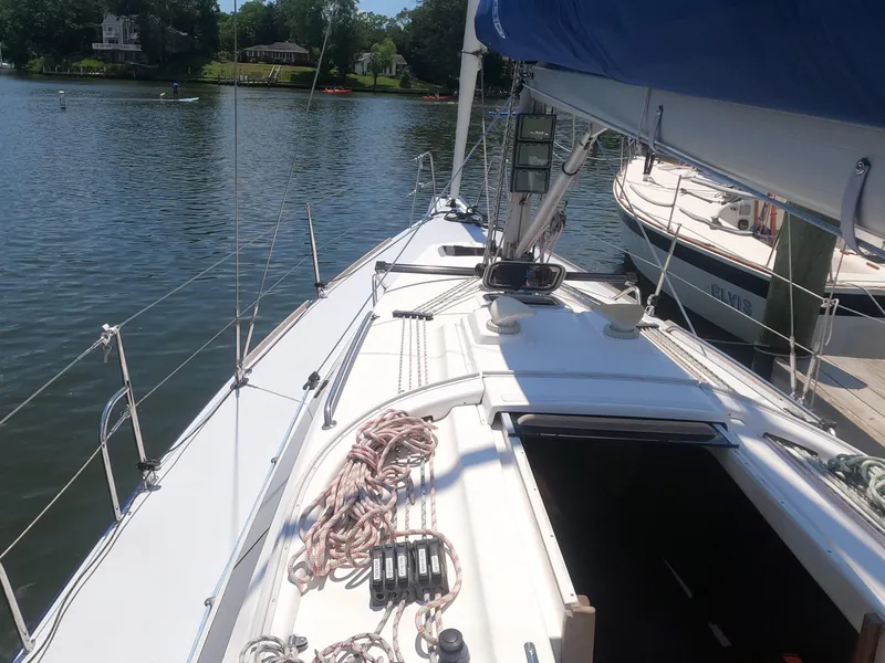 Slide: The Image of Finn Flyer 33 R 2010 sailboat docked on a calm lake. - 10