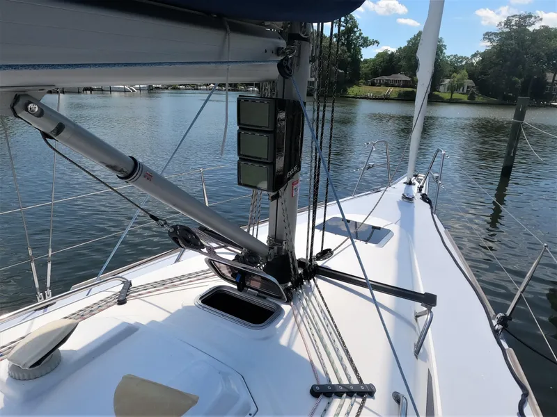 Slide: The Image of 2010 Finn Flyer 33 R sailboat deck with mast and rigging on a calm waterway. - 11