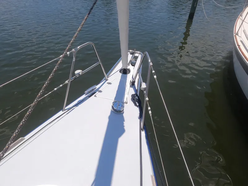 Slide: The Image of Bow of a 2010 Finn Flyer 33 R sailboat docked in calm waters. - 13