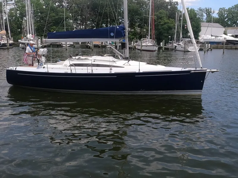 Slide: The Image of 2010 Finn Flyer 33 R sailboat docked in a marina. - 2