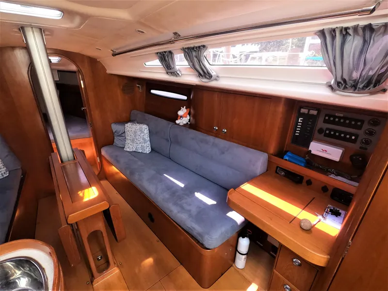 Slide: The Image of Interior of 2010 Finn Flyer 33 R sailboat with blue sofa and wooden cabinetry. - 25