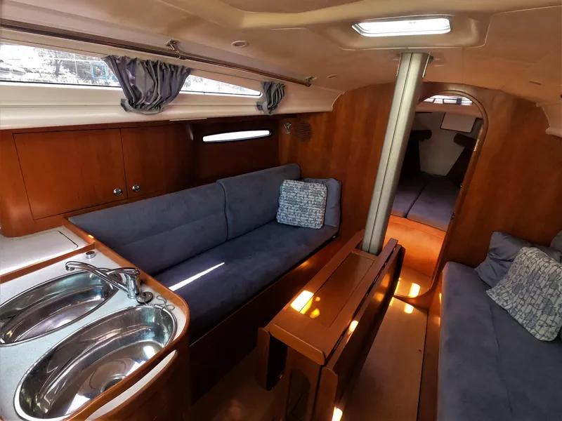 Slide: The Image of Interior of 2010 Finn Flyer 33 R sailboat with blue seating and wooden finishes. - 27