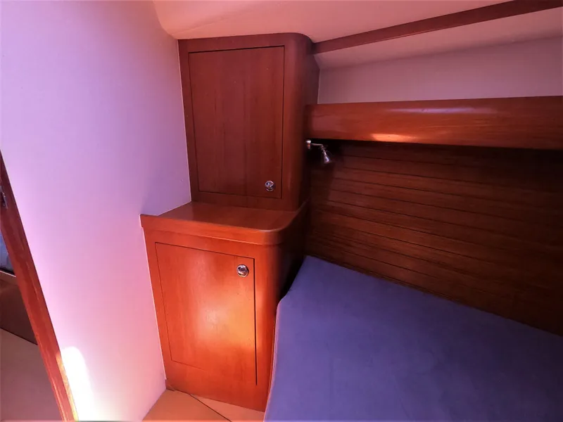 Slide: The Image of Finn Flyer 33 R 2010 yacht interior with wooden cabinets and bed. - 32