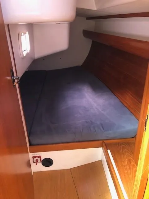 Slide: The Image of 2010 Finn Flyer 33 R cabin with wooden interior and cozy sleeping area. - 33