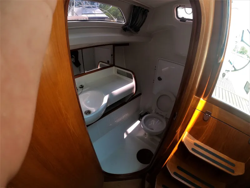 Slide: The Image of 2010 Finn Flyer 33 R yacht bathroom with sink, toilet, and wooden accents. - 36