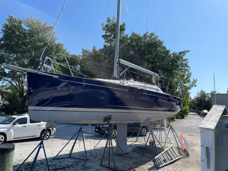 Slide: The Image of 2010 Finn Flyer 33 R sailboat on stands in a boatyard. - 39
