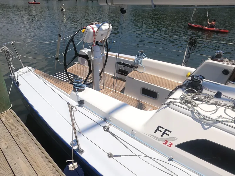 Slide: The Image of 2010 Finn Flyer 33 R sailboat docked, showing deck and steering wheel. - 6