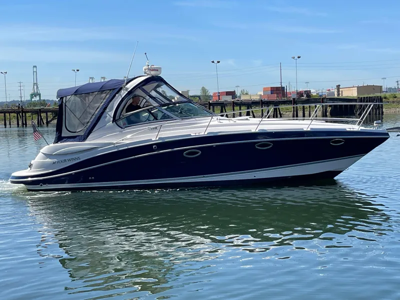 The Image of 2008 Four Winns V338 boat cruising on calm water. - 0