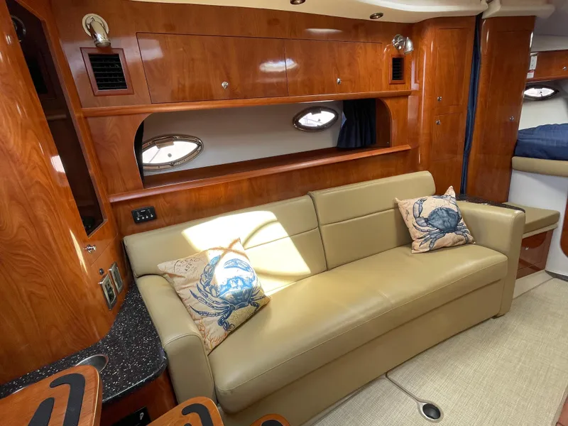 Slide: The Image of 2008 Four Winns V338 yacht interior with beige leather sofa and wooden cabinetry. - 17