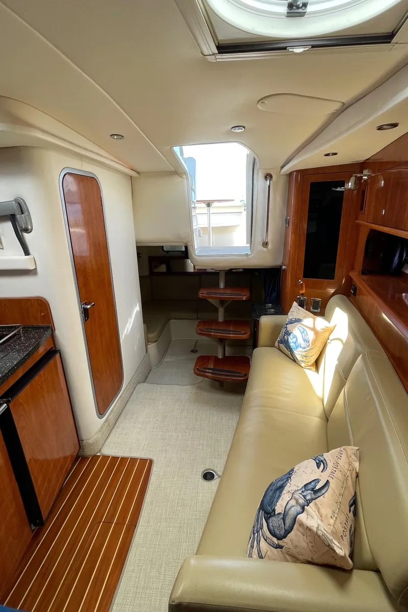 Slide: The Image of Interior of 2008 Four Winns V338 yacht with beige seating and wooden accents. - 25