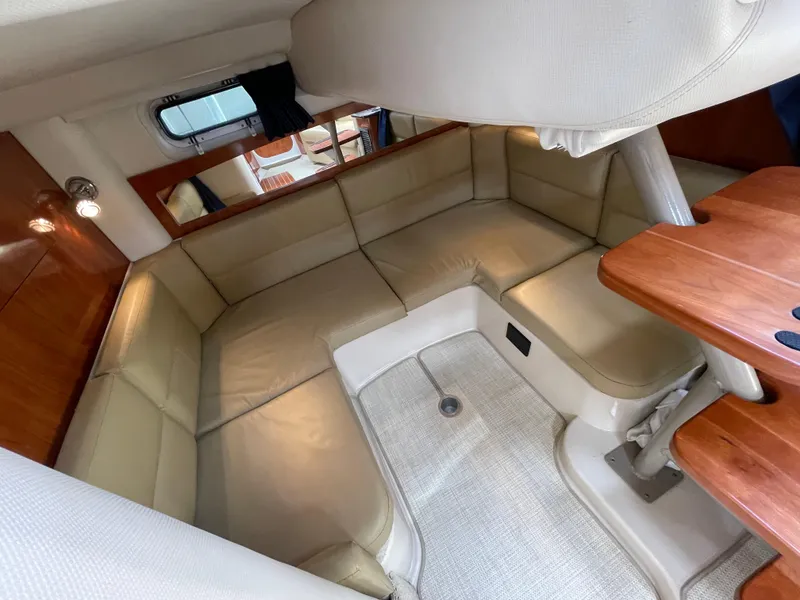 Slide: The Image of 2008 Four Winns V338 cabin interior with beige seating and wooden accents. - 26