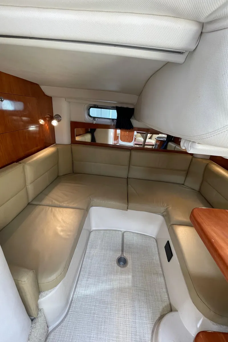Slide: The Image of 2008 Four Winns V338 boat interior with beige leather seating and wood accents. - 28
